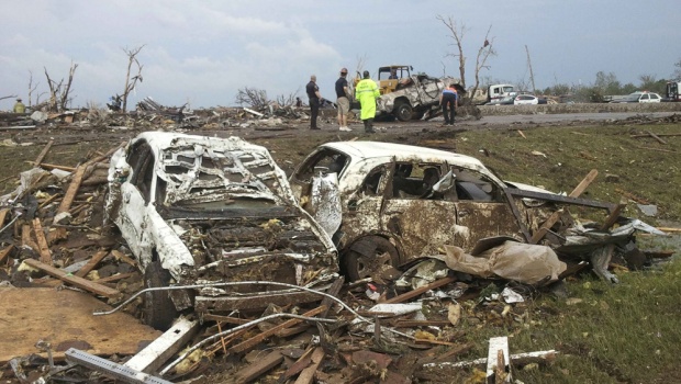 Destroyed cars are seen after a huge tornado struck Moore, Oklahoma